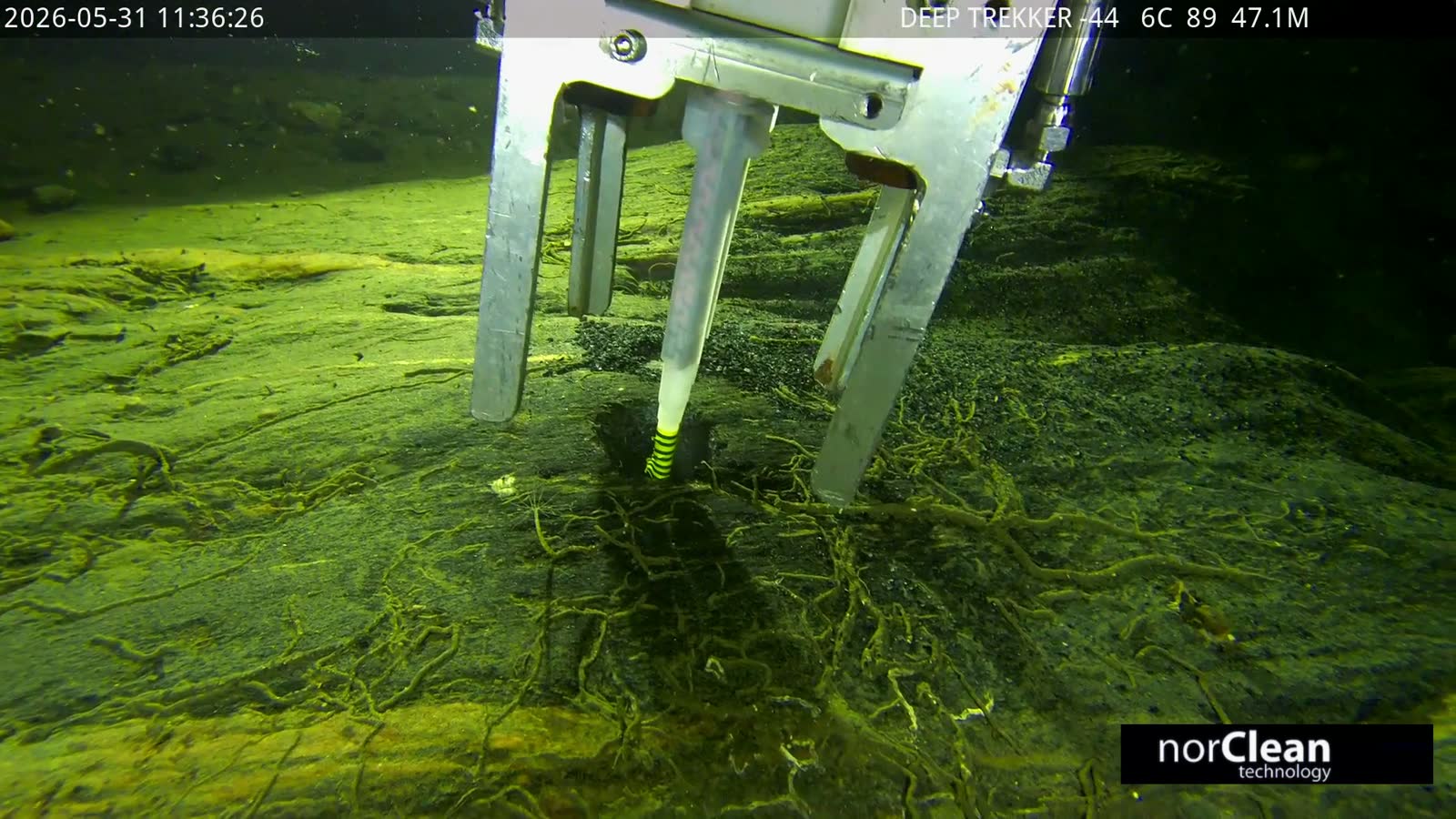 Work-class ROV with drilling system operating against a subsea rock face